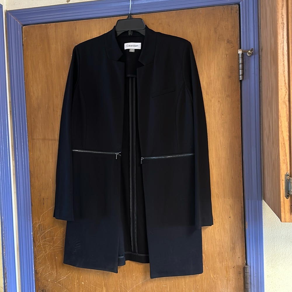 Unlined, long jacket with zipper detail.  NWOT.